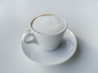 White latte coffee Cup on white table. 
