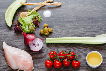 ingredients for cooking, chicken breast and vegetables on a wooden table - 231070156