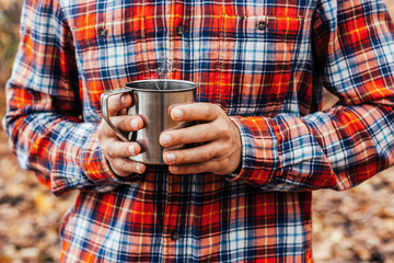 Man holding the cup with a hot drink