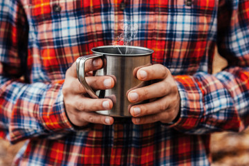 Man holding the cup with a hot drink