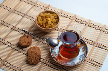 Homemade oatmeal cookies with a cup of tea on old wooden background, A cup of tea with raisin, a cup of tea with chocolate