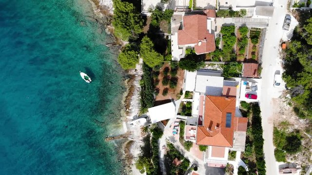 Croatian Paradise, Aerial View of coastal town with boats, slowly zooming out from above