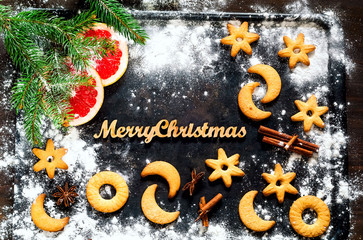 Christmas background. Festive cookies on black background. Concept celebration and cooking. New Year and Christmas card.Top view, close up, copy space