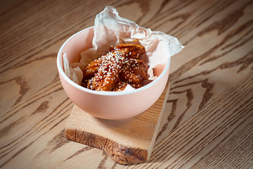 fried chicken wings with sesame in the plate on the table