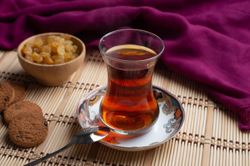 Homemade oatmeal cookies with a cup of tea on old wooden background, A cup of tea with raisin, a cup of tea with chocolate
