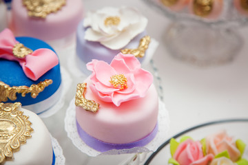 Delicious sweets on wedding candy buffet with desserts, cupcakes