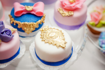 Delicious sweets on wedding candy buffet with desserts, cupcakes