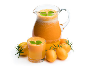 Fresh tomato juice made from the golden-yellow tomatoes in jar isolated