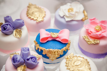 Delicious sweets on wedding candy buffet with desserts, cupcakes