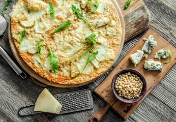 Pizza four cheeses on the table