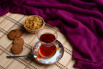 Homemade oatmeal cookies with a cup of tea on old wooden background, A cup of tea with raisin, a cup of tea with chocolate