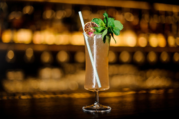Sherry Cobbler decorated with lemon, rose, mint branch and tubule