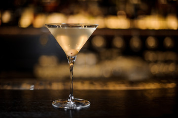 Dirty Martini cocktail with one olive in the glass