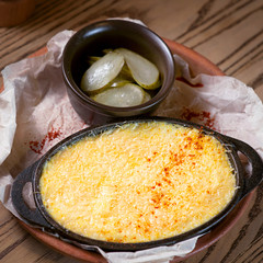 fish baked with cheese and salted cucumbers