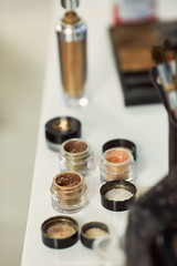 Make-up. Little bottles with glitters stand on the table