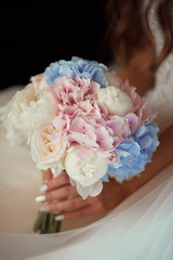 Wedding flower decor. Close-up of bride's bouquet made of pink and blue flwoers