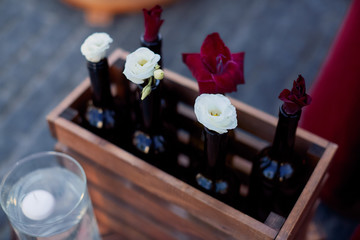 Wedding decor. Winte bottles with flowers stand on the ground