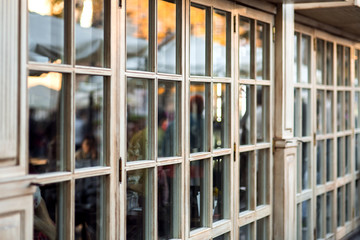 panoramic wooden windows showcase a cafe shop in retro style, the window frame made of wood is a close-up of the panoramic window nobody.