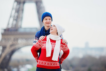 Obraz premium Happy couple near the Eiffel tower on a winter day