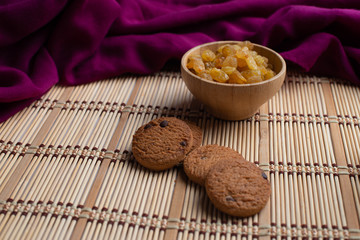 Homemade oatmeal cookies with a cup of tea on old wooden background, A cup of tea with raisin, a cup of tea with chocolate