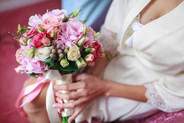 Wedding bouquet of flowers including Red hypericum, Roses, Lilies of the valley, mini Roses, Seeded Eucalyptus, Astilbe, Scabiosa, Pieris, and ivy