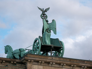 The Quadriga of Brandenburg Gate Against A Blue Cloudy Sky In Berlin, Germany