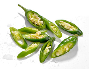 chopped green chili pepper close-up  on white background sprinkle with water
