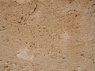 a rough light brown porous textured sandstone flat surface background