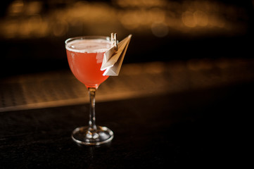 Elegant decorated glass filled with tasty Paper Plane cocktail