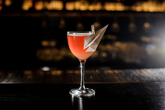 Decorated glass filled with fresh Paper Plane cocktail
