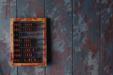 top view of vintage abacus on rustic wooden table with copy space