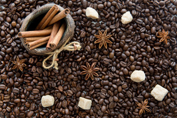 Coffee beans, anise, cinnamon sticks in a jug, brown sugar.