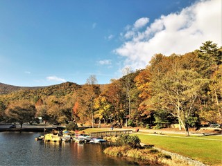 Fantastic view of colorful mountain with reflection in the lake at Vogel State park with blue sky white clouds on the background, Autumn in GA USA.