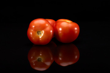 Fresh  tomatoes on black background.