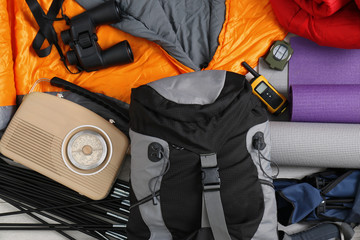 Composition with sleeping bag and camping equipment as background