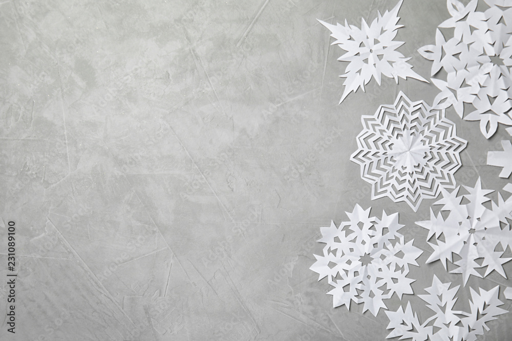 Wall mural composition with beautiful snowflakes and space for text on color background, top view. festive wint