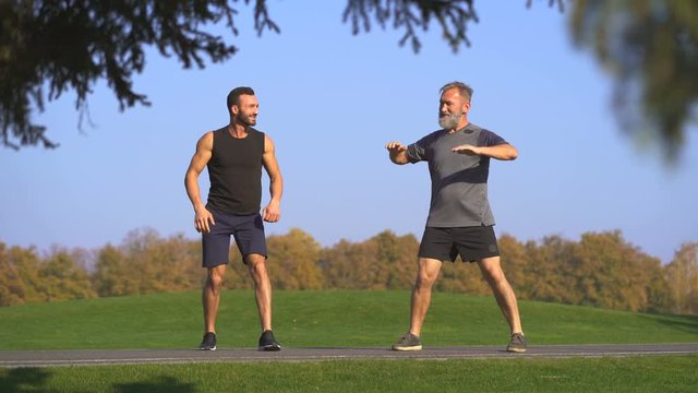 The two happy men stretching outdoor