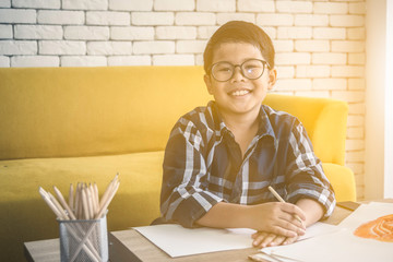 Fototapeta na wymiar Asia boy doing homework , creative boy , pre school concept
