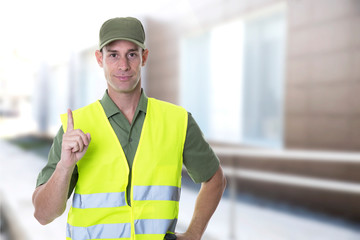 security agent with green shirt guarding a building