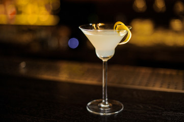 Tasty White Lady cocktail decorated with orange zest