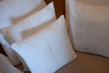 Detail of white linen cusions with lace