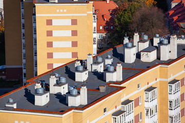 chimneys on the roof of an apartment building