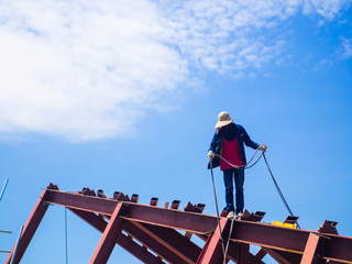 The Welder man a welding the steel roof, worker with unprotected and unsafely, Electric iron oxide.