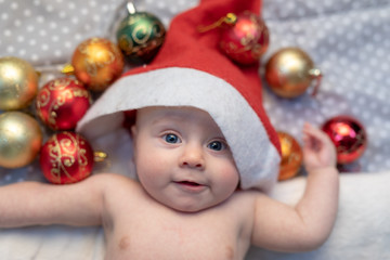 Obraz na płótnie Canvas Fun little newborn baby wearing a Santa Claus hat