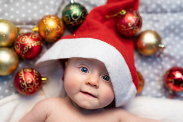 Obraz na płótnie Canvas Adorable little baby dressed in a Santa hat