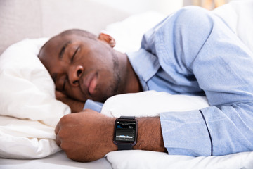 Man Sleeping With Smart Watch In His Hand - Powered by Adobe
