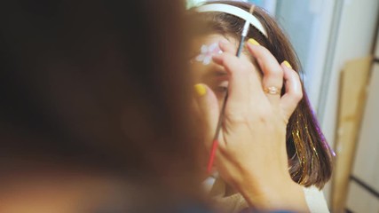 little girl paint on face painting drawing paints. preparing for the holiday childhood concept joy and happiness girl lifestyle - Powered by Adobe