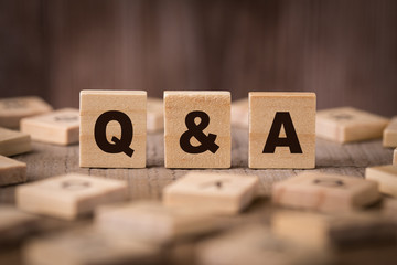 Q A Sign With Wooden Background