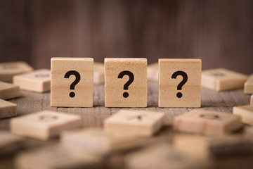 Question Mark Sign With Wooden Background