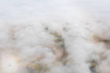 Obraz na płótnie Canvas Aerial view above clouds and fog looking down at fall color on the Alaskan tundra, Katmai National Park, Alaska, USA 
